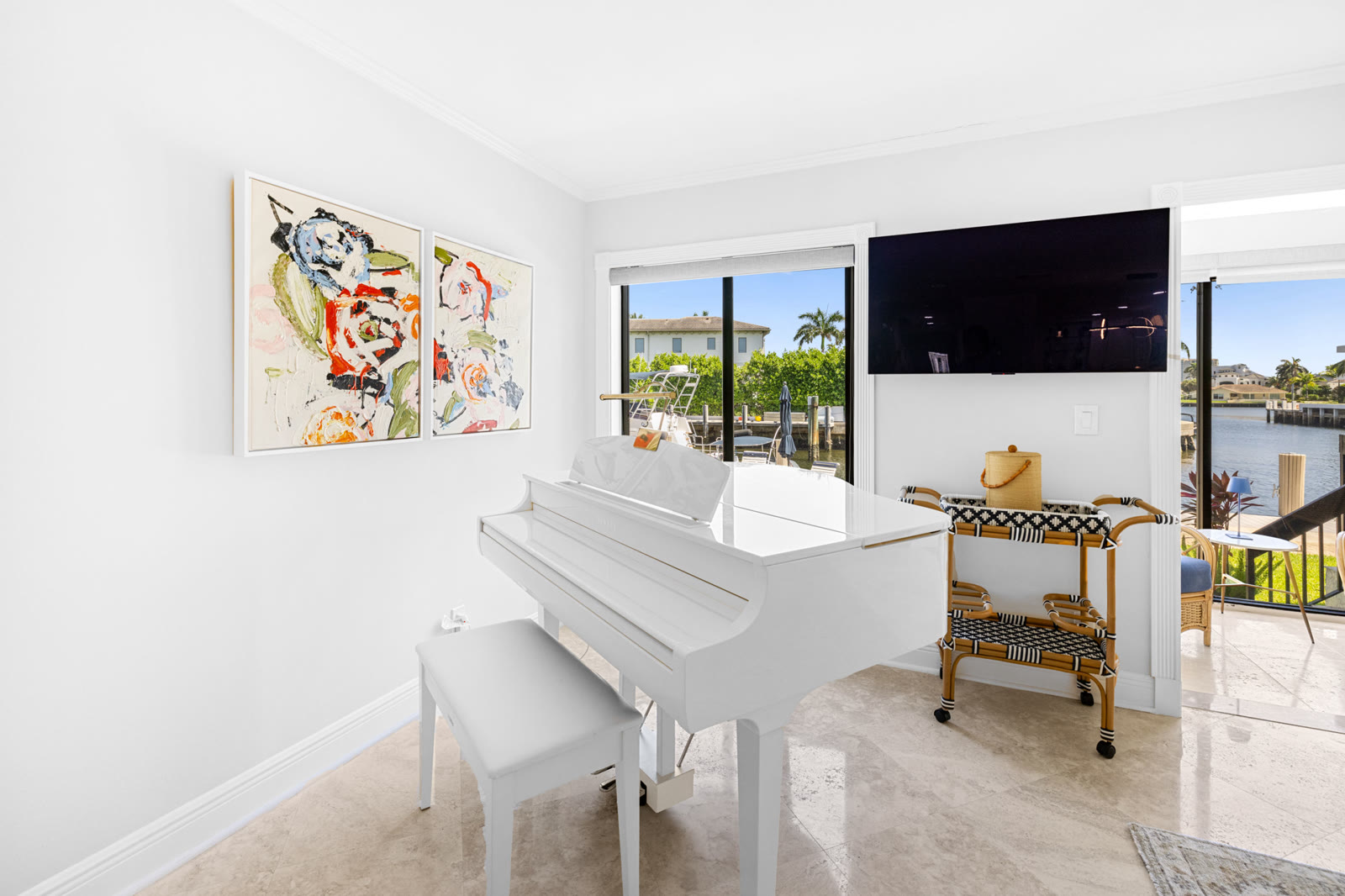 Waterfront living room with white grand piano