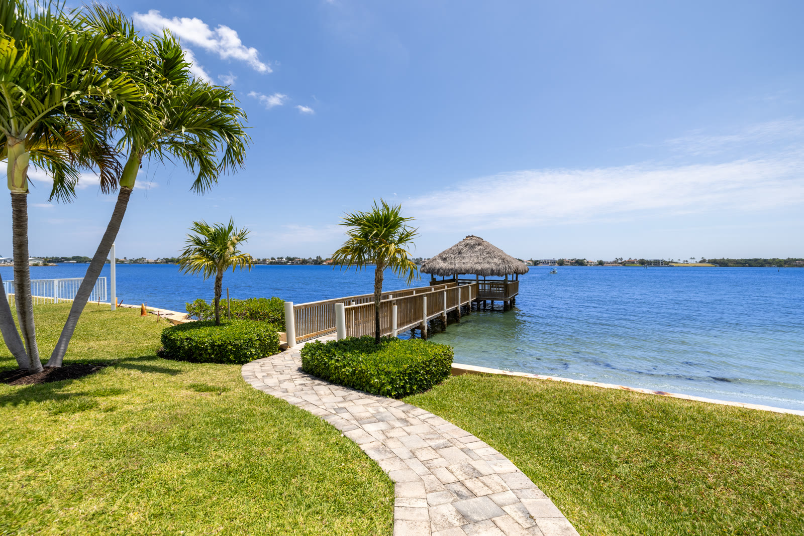 Waterfront dock with thatched tiki hut on the Intracoastal in daylight