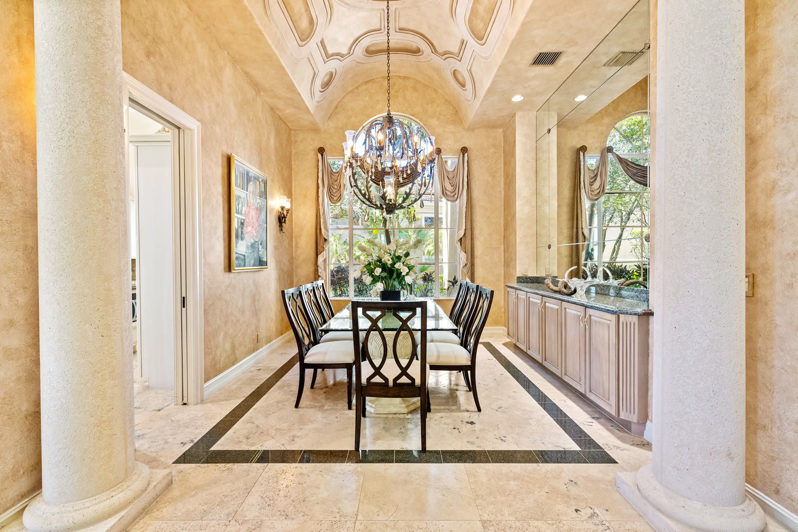 Formal dining room with vaulted ceiling and crystal chandelier