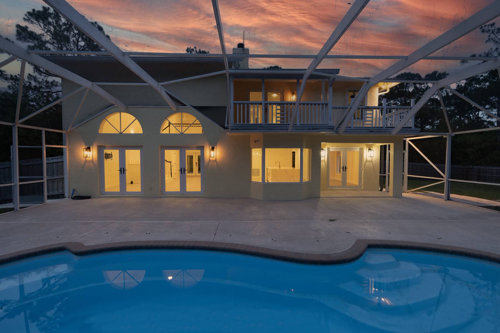 Exterior pool at night in a South Florida luxury home